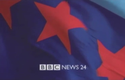 BBC NEWS 24 ident with BBC logo and channel name in white at the
					bottom of the screen on top of a flying blue flag with red stars
					(15K)