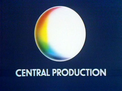White circle, with a rainbow-coloured crescent 'shadow' on the left, above CENTRAL PRODUCTION in white. (20K)