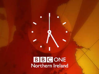 White clock with BBC ONE Northern Ireland underneath all on a red and orange background