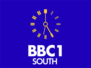 Yellow clock with white BBC 1 SOUTH lettering underneath