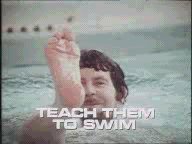 Rolf Harris in a swimming pool, waving with his foot, with a caption: TEACH THEM TO SWIM