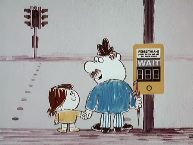 Man and his granddaughter wait to cross the road at a pelican crossing.