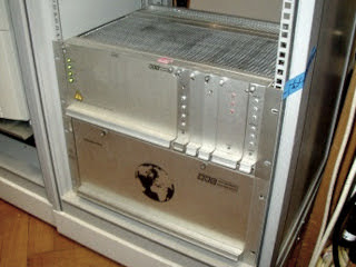 Silver box in a rack with a globe symbol on the front