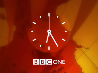 White clock with BBC ONE underneath all on a red and orange background