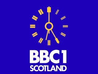 Yellow clock with white BBC 1 SCOTLAND lettering underneath